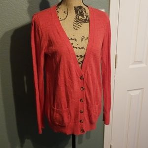 Long sleeved red cardigan with turtle buttons